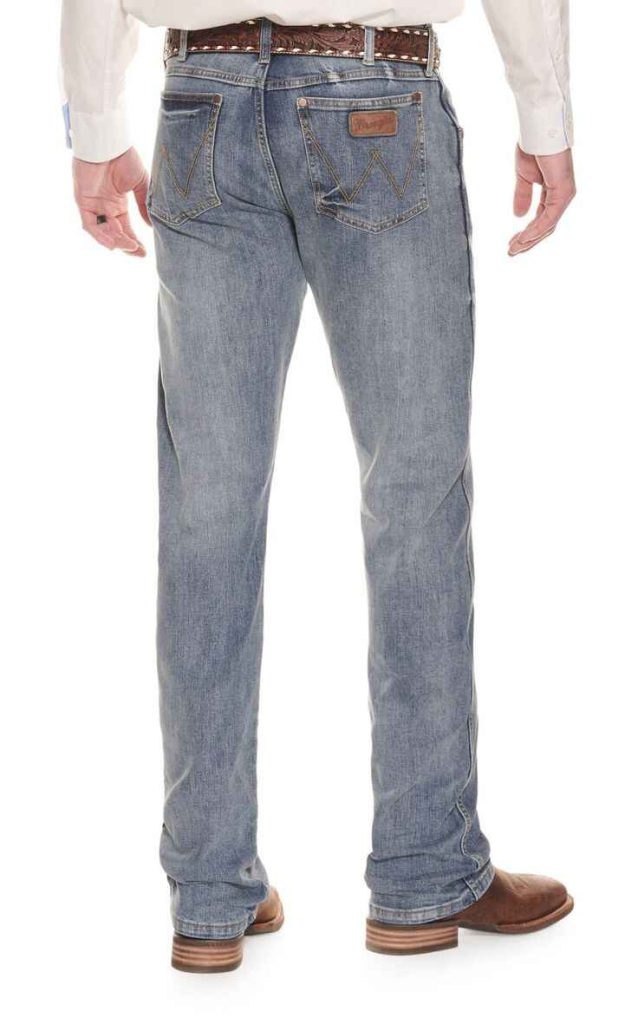 Men's classic relaxed fit Wrangler jeans with leather belt and brown boots.